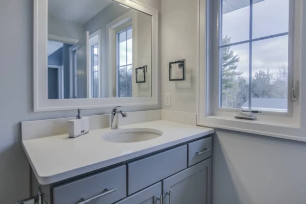 IMG_6483Blended Modern bathroom with a gray vanity, round sink, large mirror, and window showing an outdoor view.